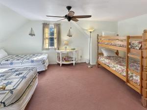a bedroom with two beds and a ceiling fan at Family Retreat at York Beach in York