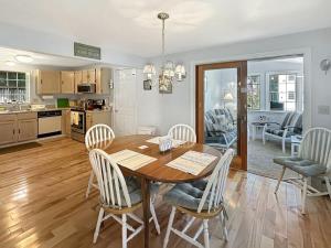 a kitchen and dining room with a wooden table and chairs at Family Retreat at York Beach in York