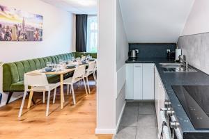 a dining room with a table and chairs at Etagenwohnung 110qm in der Villa Winckelmann in Berlin
