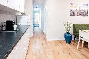 a kitchen with a black counter top and a refrigerator at Etagenwohnung 110qm in der Villa Winckelmann in Berlin +3 photos
