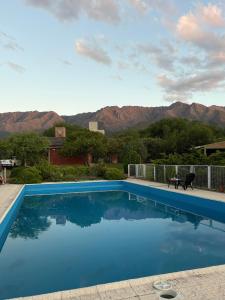 a swimming pool with a view of the mountains at Complejo Ayllu in Las Rabonas