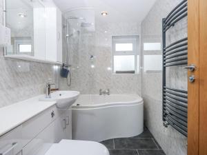 a white bathroom with a sink and a toilet at Benlli in Pwllheli +13 photos
