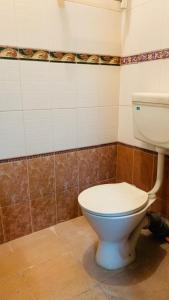 a bathroom with a white toilet in a room at JS Homestay in Nāgercoil