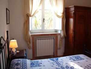 a bedroom with a bed and a window and a radiator at Casa PAGLIERA in Porto San Giorgio
