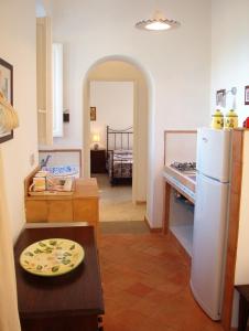 a kitchen with a refrigerator and a table in a room at Casa PAGLIERA in Porto San Giorgio