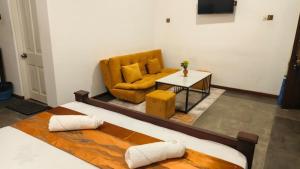 a living room with a couch and a table at Ovenro Safari Hotel & Restaurant Yala, Kataragama in Kataragama