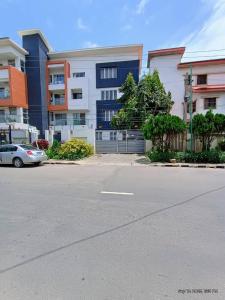 a car parked in front of a building at EXCLUSIVE ANSO Homes GRA Ikeja 1 bed room in Ikeja