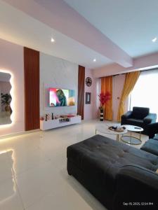 a large living room with a couch and a tv at EXCLUSIVE ANSO Homes GRA Ikeja 1 bed room in Ikeja