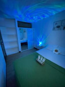 Un dormitorio con una cama con techo azul. en PAID AirprtPck-up WrkNrelax 2TV with Netflx, en Lanang