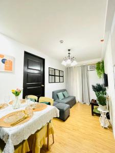 una sala de estar con una mesa y un sofá en PAID AirprtPck-up WrkNrelax 2TV with Netflx, en Lanang