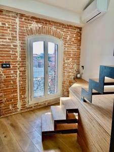 sala de estar con pared de ladrillo y escalera en Le nid - Centre ville - Capitole- Climatisé, en Toulouse