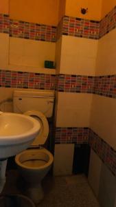 a bathroom with a toilet and a sink at JS Homestay in Nāgercoil