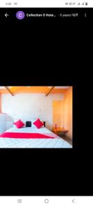 a bedroom with a bed with red pillows at Hotel paladise in Ahmedabad