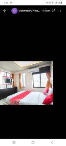 a picture of a bedroom with a bed with red pillows at Hotel paladise in Ahmedabad