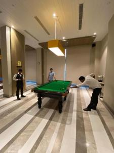 a group of people playing pool in a room at Hotel Four Season - Gomtinagar - Lucknow in Lucknow
