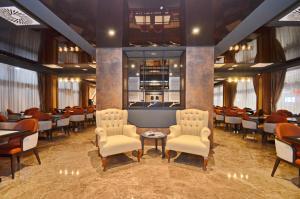 a restaurant with chairs and a table in a room at Hotel Aleksandar Conference & Spa in Žabljak