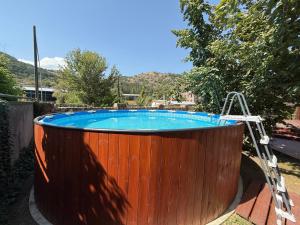 a wooden hot tub with a ladder around it at Sayat Nova Home in Dilijan