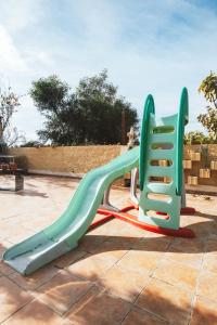 two plastic slides sitting on a playground at Villa en Lorca 2 Piscinas Vistas Gran Terraza y Barbacoa-Venta Ruizo Hasta 20 personas in Lorca
