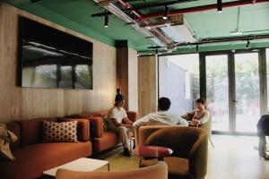 a group of people sitting in a waiting room at Coliving for Master, Postgrads and Language Learners in Barcelona