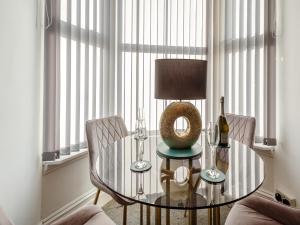 a dining room with a glass table and two chairs at Jack's House- Uk40741 in Tywyn