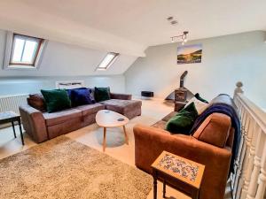 a living room with two couches and a stove at Jack's House- Uk40741 in Tywyn +37 photos