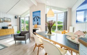 a dining room and living room with a table and chairs at Friedrichskoog-Deichblick 16 in Friedrichskoog