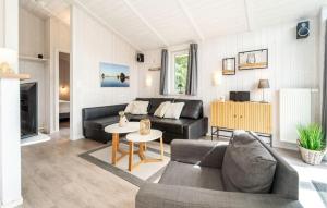 a living room with a couch and a table at Friedrichskoog-Deichblick 16 in Friedrichskoog