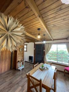 a dining room with a table and a large wooden ceiling at Complejo El Yanten in Villa Ventana