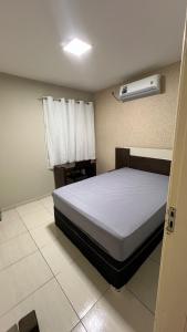 Piranhas casa de temporada في ببرانا: غرفة نوم بها سرير ونافذة