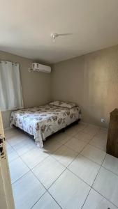 Piranhas casa de temporada في ببرانا: غرفة نوم بسرير في زاوية الغرفة +10 صور