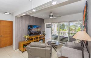 a living room with a couch and a table at El Neptuno Residencial, Sosua in Sosúa