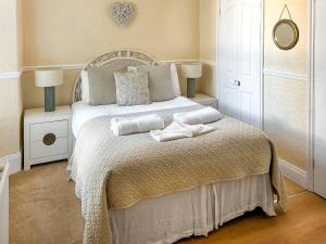 a bedroom with a bed with two towels on it at Bora House in Newquay