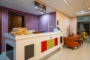 a lobby with a colorful reception counter in a store at Linda Sunny Beach Hotel & Spa-Ultra All Inclusive in Side +63 photos