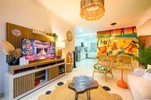 a living room with a couch and a tv at Lamarel Beach House 2 in Flic-en-Flac