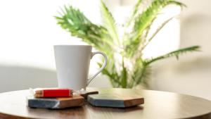a coffee cup sitting on top of a wooden table at Spacious Canalside Cottage - Games Room - Dog Walks in Loughborough