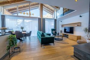 a living room with a couch and a dining room at Matthiol Appartements in Zermatt