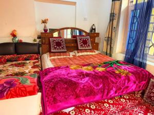 two beds sitting next to each other in a room at Habib Guest House GULMARG 11 in Tangmarg