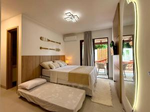 een slaapkamer met 2 bedden en een deur naar een patio bij Casa Verano - Morro de São Paulo in Morro de São Paulo +61 foto's