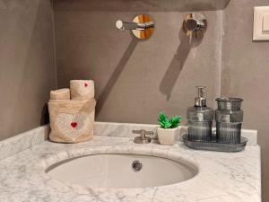 a bathroom counter with a sink and towels at Lac & Love - Alpine Escape in Crans-Montana +25 photos