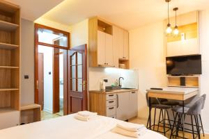 a small kitchen with a table and a counter at Apartmani Central & Free parking in Vrnjačka Banja