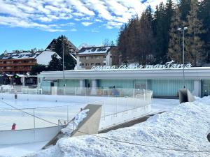 a skate park in front of a building with snow at Lac & Love - Alpine Escape in Crans-Montana