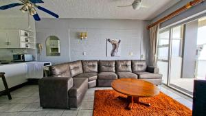 a living room with a couch and a table at Seagull 505 in Margate