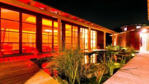 a house with a deck with a pond in front of it at Medical Wellness RehaKlinik und Aqualon Therme in Bad Säckingen