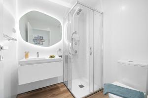 een witte badkamer met douche en wastafel bij Peace Haven III in Câmara de Lobos +50 foto's