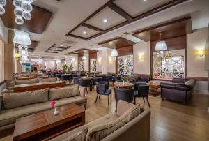 a lobby with couches and chairs and tables and a bar at Linda Sunny Beach Hotel & Spa-Ultra All Inclusive in Side