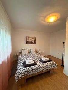 a bedroom with a bed with two pillows on it at Apartman Tijana in Ruma +7 photos