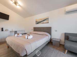 En eller flere senge i et værelse på Villa Monica