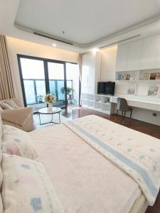 a large bedroom with a large bed and a living room at Căn hộ homestay Doji Diamond Crown in Hai Phong