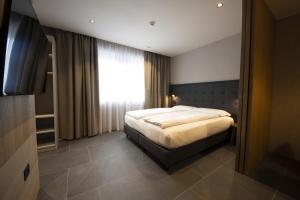 En eller flere senge i et værelse på Dolomiten Apartments