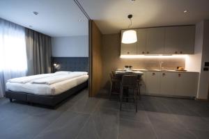 En eller flere senge i et værelse på Dolomiten Apartments